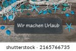 Chalk board with the text wir machen Urlaub,wir machen Urlaub translated means we