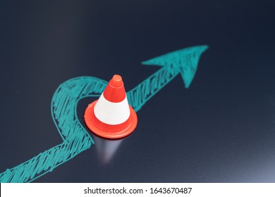 Chalk Drawing Arrow Turn Or Break Through Road Block Traffic Pylon On Dark Blackboard Using As Obstacle, Solution For Business Problem Or Break Through To Success Concept.