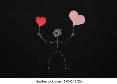 Chalk drawing man is holding red hearts  Blackboard chalkboard background  Valentines day  love  relationship  attraction concept  Flat lay