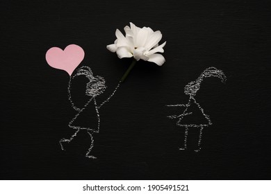 Chalk drawing woman is holding red heart   flower   running to girl  Blackboard chalkboard background  Valentines day  love  relationship  attraction concept  Flat lay
