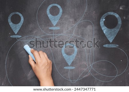 Chalk drawn trajectories to destination path on black chalk board