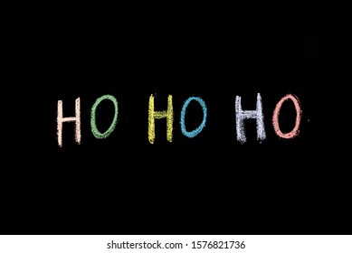 chalk drawn words ho ho ho on blackboard