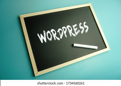 Chalk and mini blackboard written wordpress over blue background