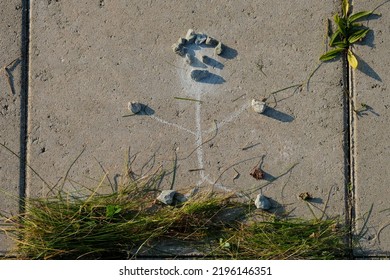 A Chalk Picture Of A Person Decorated With Rocks