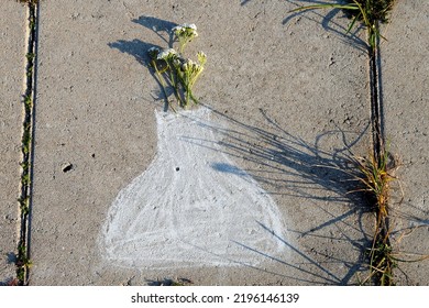 A Chalk Picture Of Vase With Real Flowers