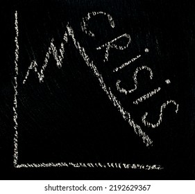 Chalk Writing Of The Word Crisis With A Drawn Diagram On A Black Rough Background. Energy Crisis And Embargo On The Sale Of Gas And Oil In Europe. Financial Crisis And Revenue Decline Chart