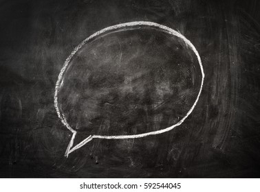 Chalkboard background. Comics speech bubble drawn on the black chalkboard.