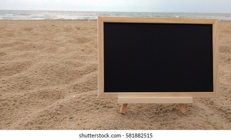 chalkboard on sandy beach. Composition of Nature.

