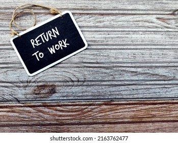 Chalkboard On Wood Copy Space Background With Handwritten Text RETURN TO WORK, Process Of Bringing Employees Back To Workforce Workplace After Absence Period Of Covid-19 Pandemic