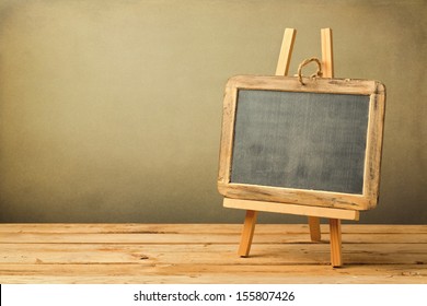 Chalkboard On Wooden Easel On Wooden Table