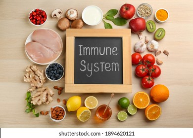 Chalkboard with phrase Immune System and fresh products on wooden table, flat lay - Shutterstock ID 1894620121