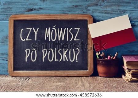a chalkboard with the question czy mowisz po polsku?, do you speak Polish? written in Polish, a pot with pencils, some books and the flag of Poland