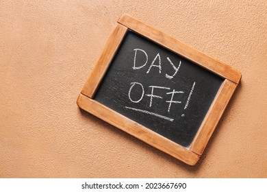 Chalkboard with text DAY OFF on color background