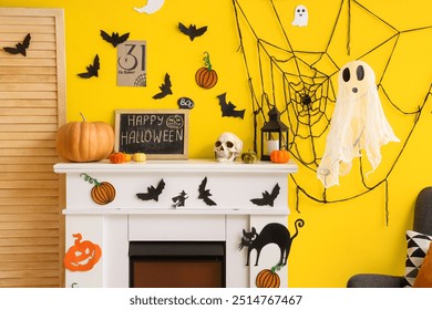 Chalkboard with text HAPPY HALLOWEEN and decor on fireplace near yellow wall in room - Powered by Shutterstock