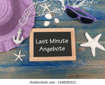 Chalkboard with the text Last Minute Angebote and maritime decoration. Last Minute Angebote means last minute offers.