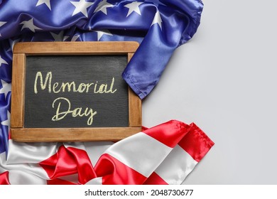 Chalkboard with text MEMORIAL DAY and USA flag on grey background - Shutterstock ID 2048730677