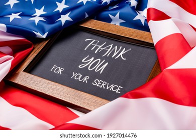 Chalkboard With Thank You For Your Service Lettering On American Flag 