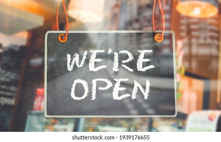 Chalkboard Of We're Open Hang On Door Or Window Of Business Shop 