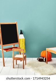 Chalkboard And Wooden Chair With Pencil And Balls On Blue Wall In Kids Room