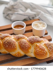 challah with batter and honey on wooden background towel sliced 