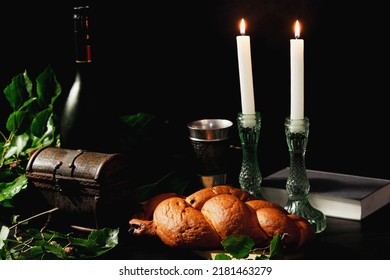 Challah bread, shabbat wine and two candles on table. Shabbat Shalom.