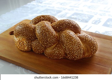 Challah on kitchen wooden cutting board. Jews eat Challah on Shabbat and on holidays. Challah (Hallah) - Jewish bread on Israel and the Jewish diaspora