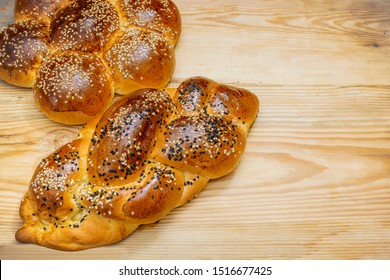 Challah with sesame seeds on wooden background