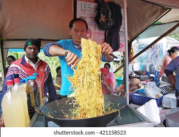 Chamarel, Mauritius. August 2010. Mauritan Asian Man Skilfully Preparing Noodles In A Wok At A Food Tent During The Village Fair.