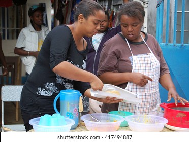 Chamarel, Mauritius, August 2010. Two African Women Prepare Street Food At Local Fair, On The Village Streets