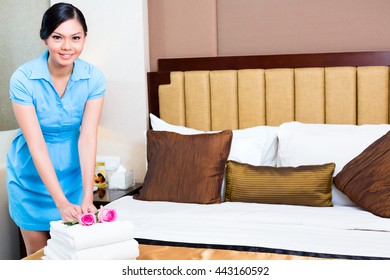 Chambermaid Cleaning In Asian Hotel Room