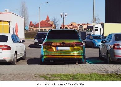 Chameleon Colour Car On The Parking Among Other Cars. Unique Bright Colour Vehicle. Custom Paint Wrap. Eye-catching Concept Photo.