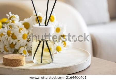 Chamomile flavour air freshener, home aroma fragrance diffuser in bed over. Healthy lifestyle and interior elements