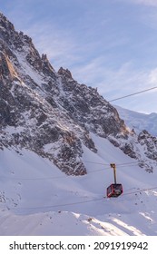 Chamonix Mont Blanc, France - January, 28, 2015: Cable Car From Chamonix To The Summit Of The Aiguille Du Midi And Pink Sunset Snow Mountains Panorama Of French Alps
