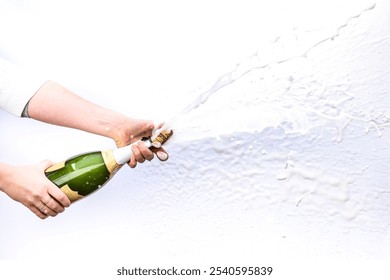 Champagne Bottle Being Popped with Bubbles and Spray Against a White Background - Powered by Shutterstock