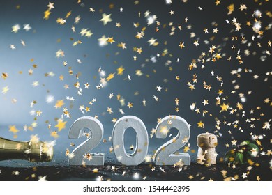 champagne bottle with confetti and champagne cork with number 2020 - Shutterstock ID 1544442395