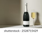 Champagne bottle and glass on minimalist surface. Elegant champagne bottle with glass, product display photo. Simple minimal backdrop with champagne bottle and glass, celebration photo