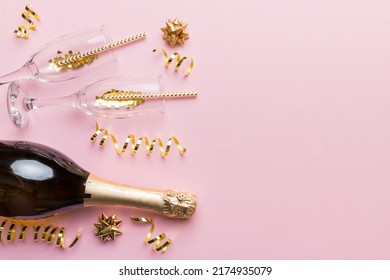 Champagne bottle, glitter and straws on color background. top view. Hilarious, christmas and birthday celebration. - Shutterstock ID 2174935079