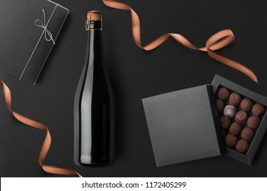 Champagne Bottle Mockup, On Black Background, With Candy, Present Boxes And Blank Label To Place Your Design