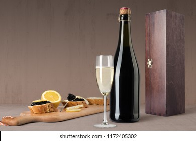 Champagne Bottle Mockup, On Wooden Background, With Glass, Caviar And Blank Label To Place Your Design