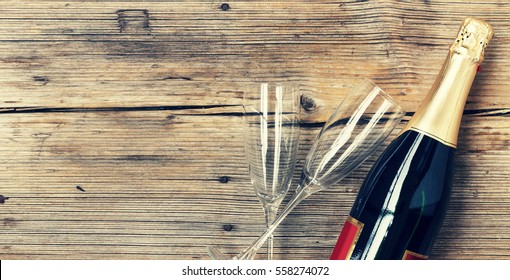 Champagne. Champagne Bottle And Two Empty Glasses On A Wooden Background. Valentine's Day. Birthday. Wedding. Anniversary. Rustic Style.