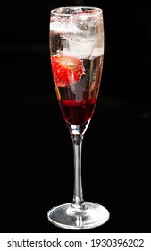 Champagne Cocktail With Liqueur And Strawberries.Isolated On A Black Background