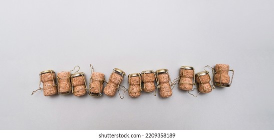Champagne corks and metal wire muselets on grey background. Collection of bottle caps from sparkling wine .