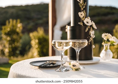 Champagne cups with dramatic wedding cake in background - Powered by Shutterstock