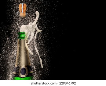 Champagne explosion on black background, celebration theme.