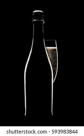 Champagne flute and bottle on black background