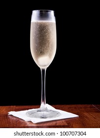 Champagne Flute Served With Sparkling Wine And A Sugar Cube Isolated On A Black Background