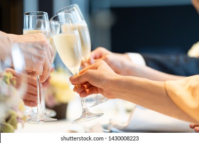 champagne glasses cheering in  wedding reception