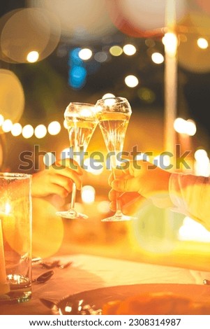 Champagne glasses and human hands,Hands holding champagne glasses on lights background 