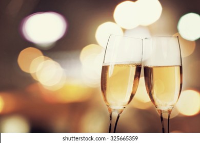 Champagne glasses on sparkling background
