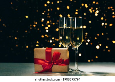 Champagne glasses of Valentine's day lights and gift box, romantic concept
